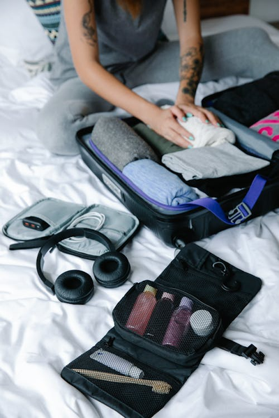 An image of a woman packing her travel bag