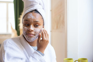 A person applying retinol wrinkle beauty cream to their face 