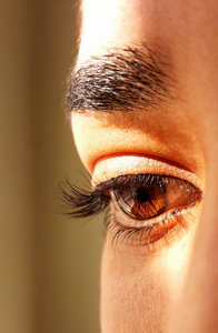  A close-up of a woman's face with long eyelashes
